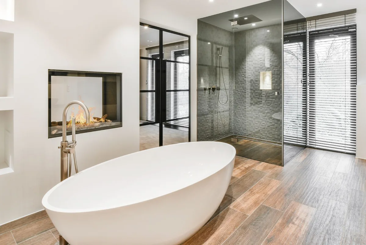 Hotel bathroom with bathtub, shower and fireplace