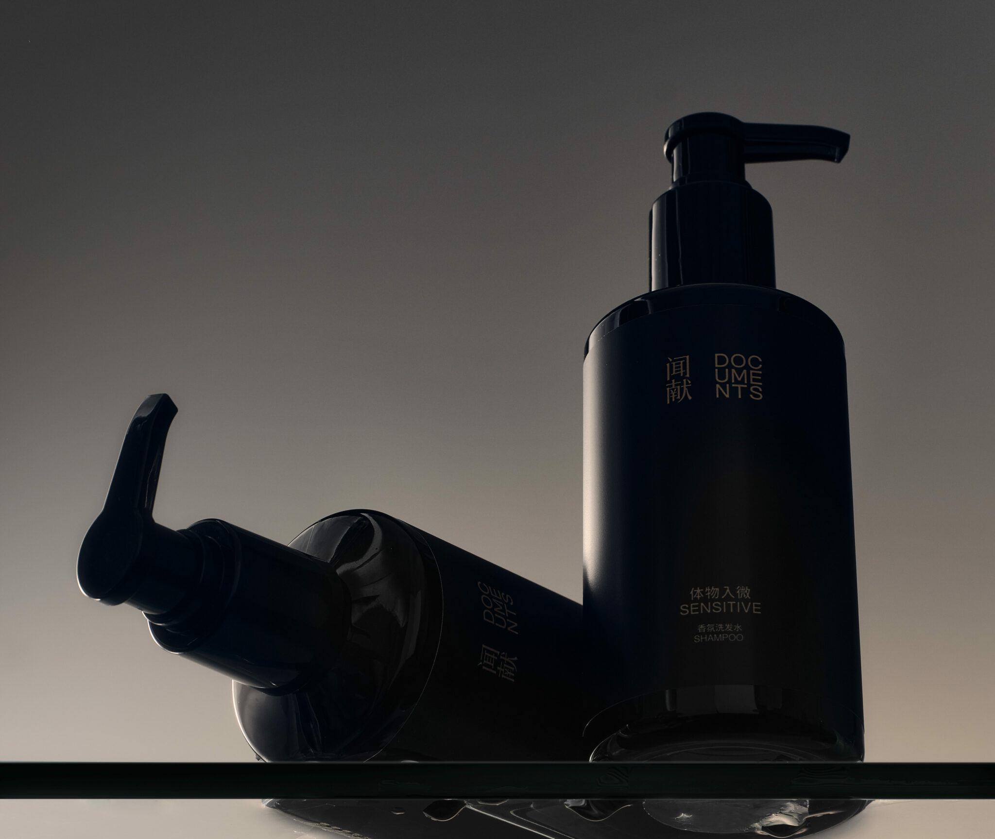 Black DOCUMENTS Sensitive pump dispensers in soft light