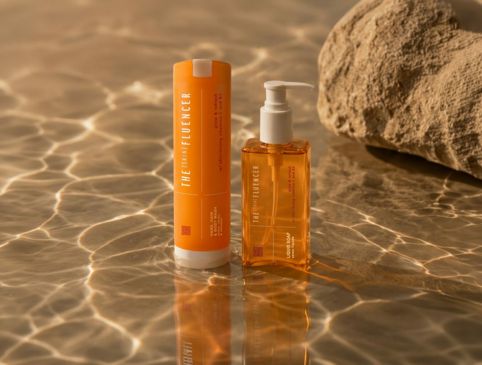 Orange The Skinfluencer bottle and pump dispenser on water in warm light